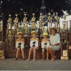 Rose poses with the boys and some of their hardware. (From left, Nicky, Tommy, and Roger.) - Photo: Hayden Family Collection
